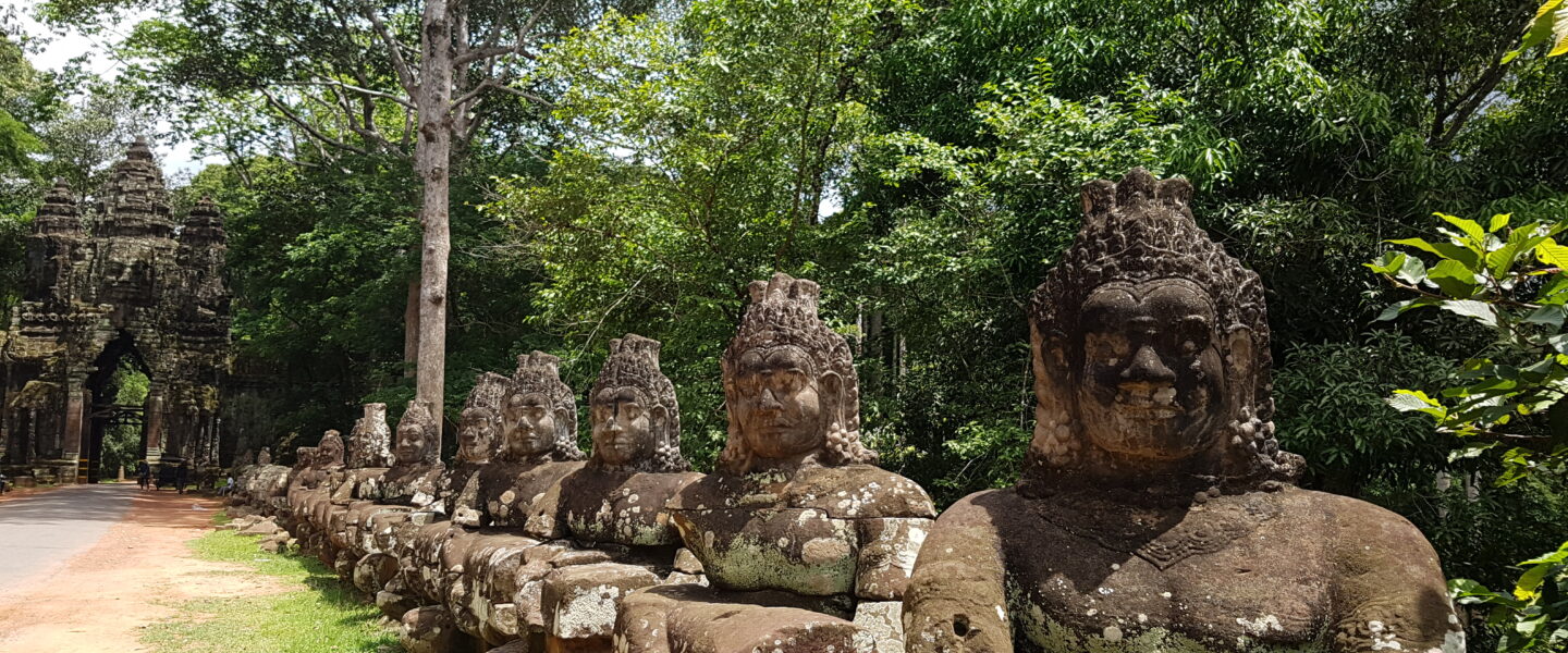 Angkor Thom stone statues holding a naga to churn the ocean of milk