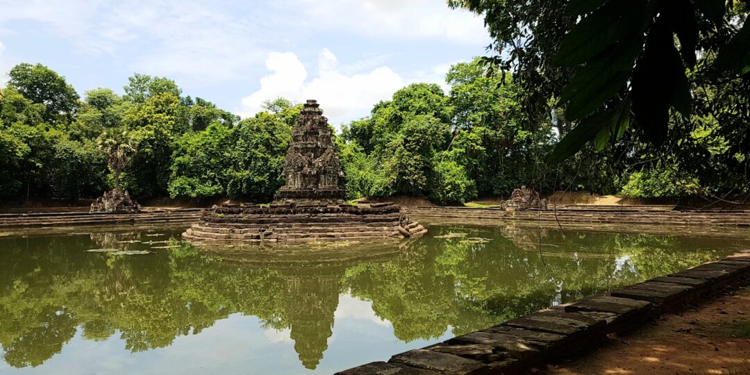 The ancient stone island temple of Neak Pean surrounded by water at Angkor Historical Park, Cambodia.
