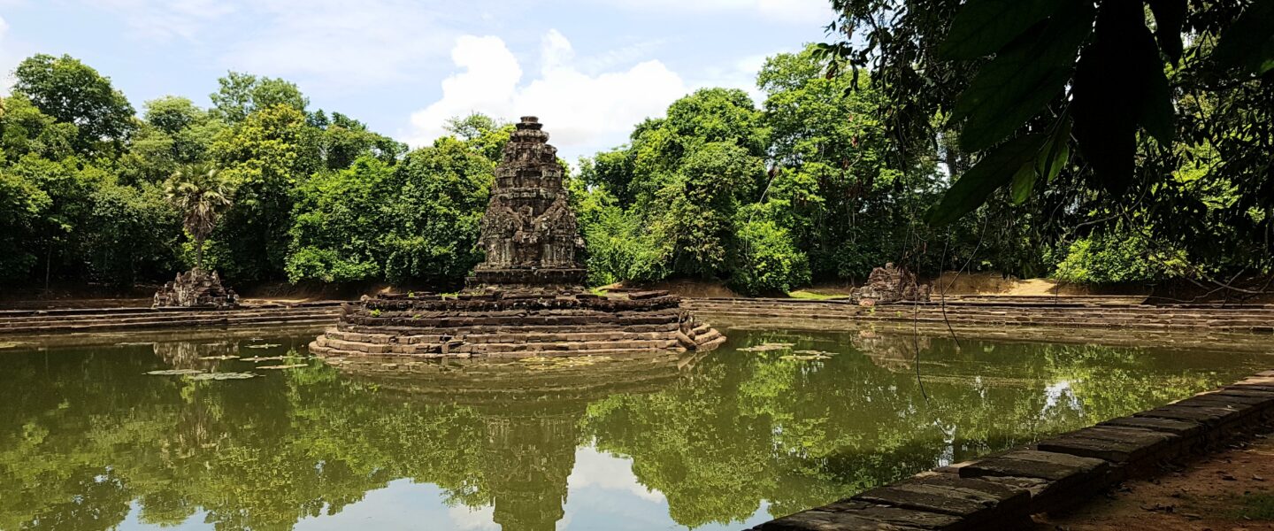 The ancient stone island temple of Neak Pean surrounded by water at Angkor Historical Park, Cambodia.